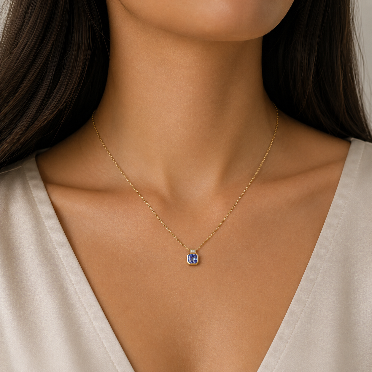 9ct yellow gold tanzanite necklace with emerald-cut diamond in rubover setting