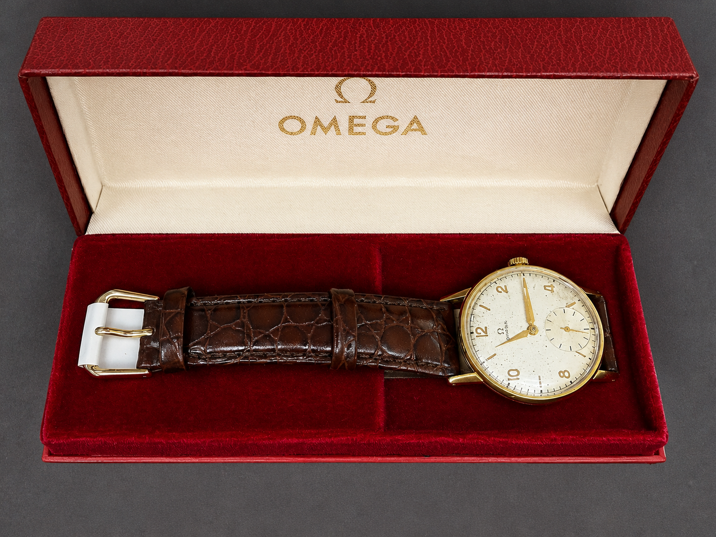 Vintage Omega gold dress watch with small seconds display and brown leather strap