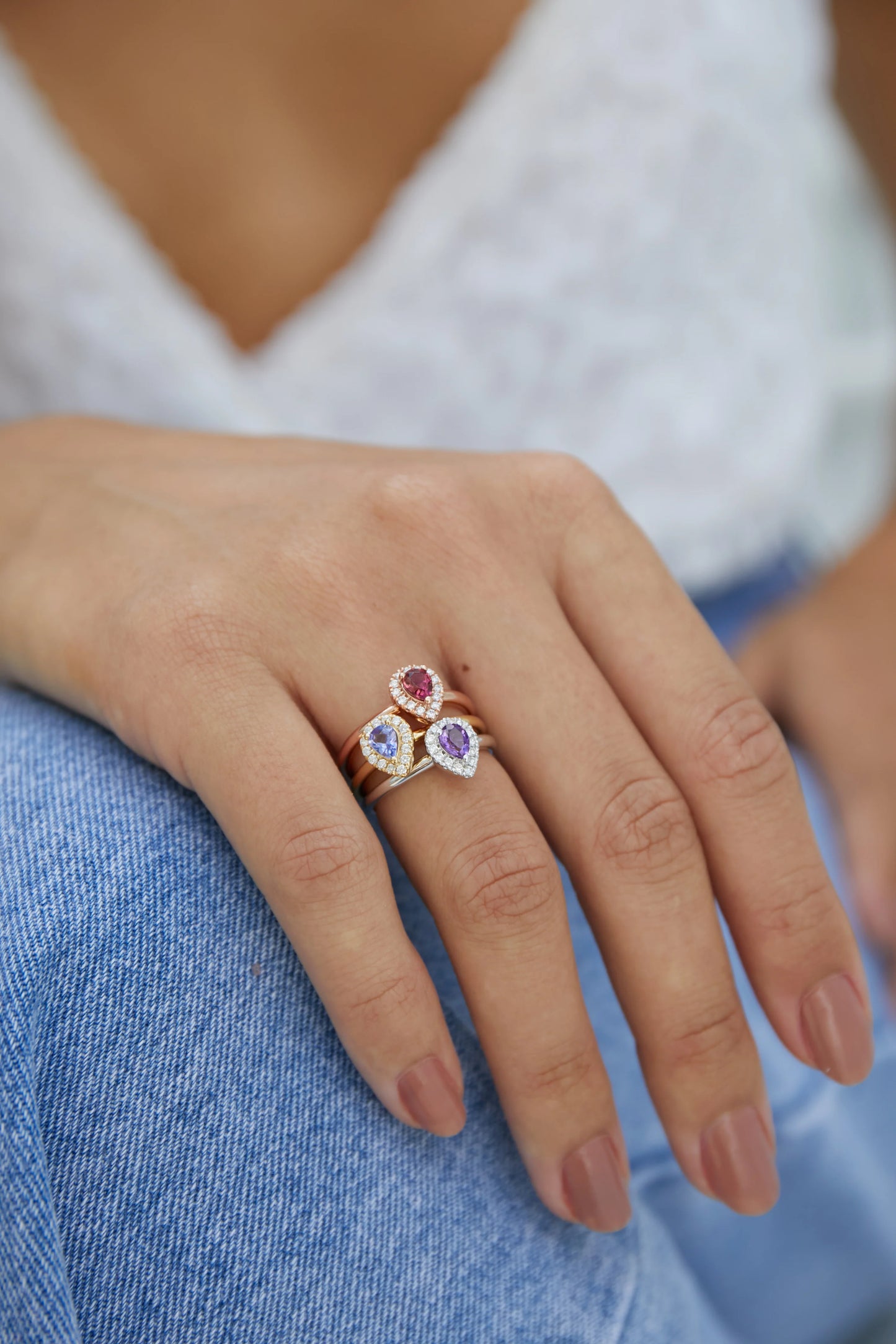 Model wearing a pear shaped pink tourmaline and diamond cluster rose gold ring