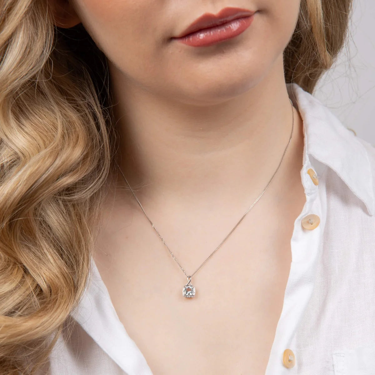 Aquamarine Twist Pendant with Diamond Surround in 9ct Gold