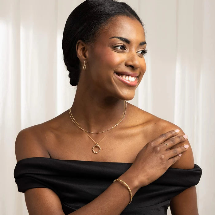 Model wearing 9ct yellow gold faceted station necklace