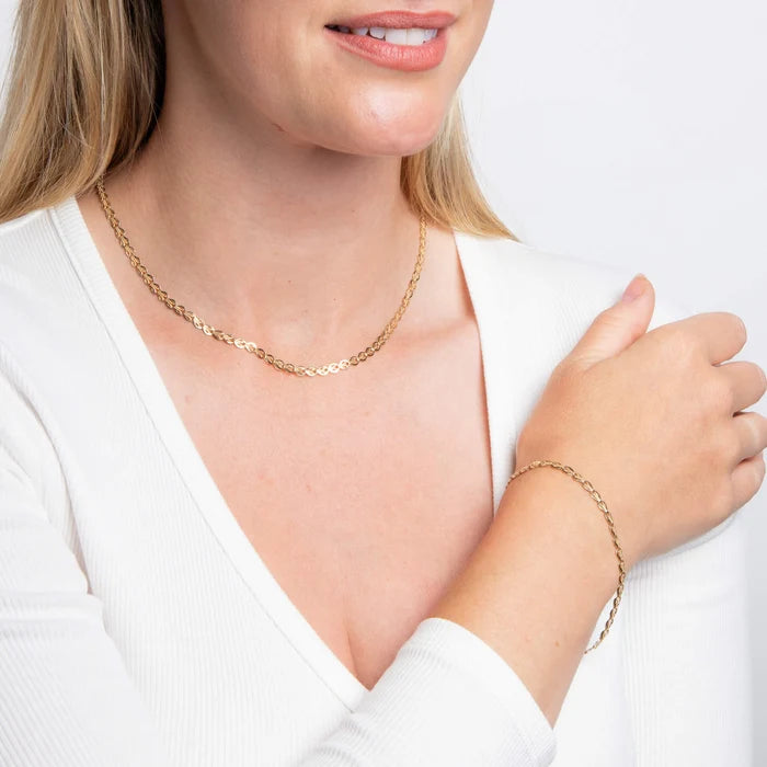 9ct yellow gold Stampato link bracelet with polished finish on the model with matching necklace 