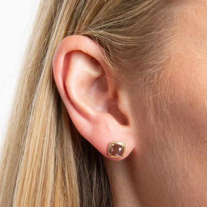 Model wearing 9ct yellow gold chocolate moonstone stud earrings with warm brown sugarloaf gemstones