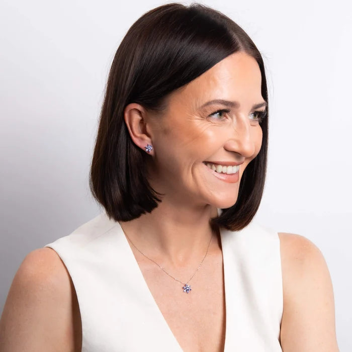 Model wearing 9ct white gold tanzanite and diamond flower pendant