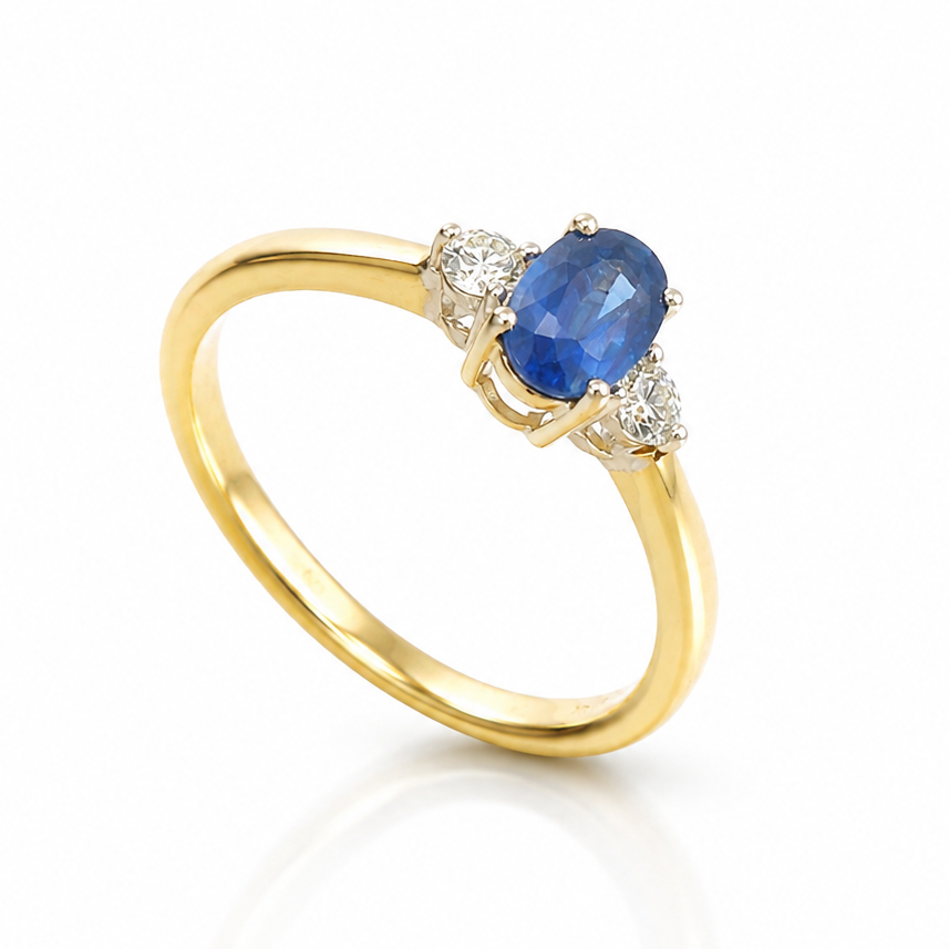 18ct yellow gold three-stone ring with 0.48ct oval blue sapphire and 0.10ct round brilliant-cut diamonds