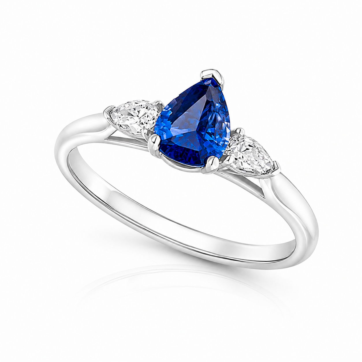 Seren platinum trilogy ring with 0.85ct pear-cut blue sapphire and pear-cut diamond side stones.