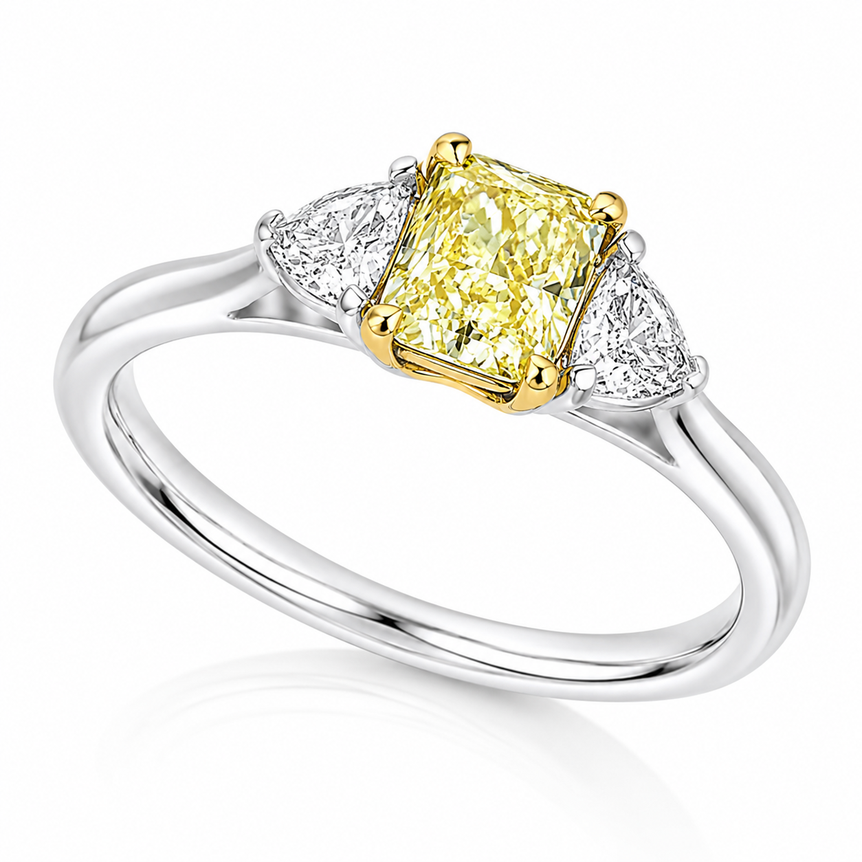 The Sol platinum trilogy ring with GIA-certified 0.71ct VS2 natural Fancy Yellow radiant cut diamond and white diamond side stones.