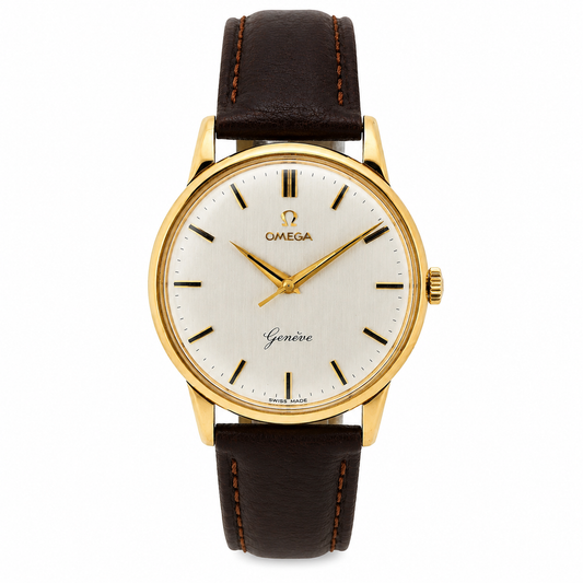 Vintage Omega Genève solid 9ct gold watch with silver sunburst dial and brown leather strap.