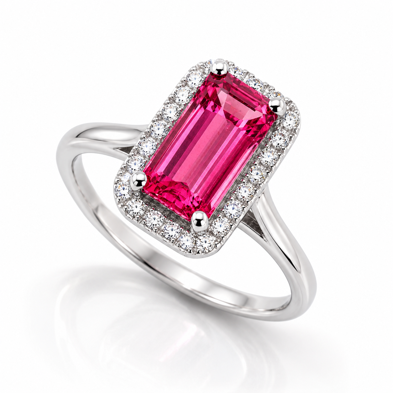 18ct white gold ring featuring a hot pink emerald-cut tourmaline with diamond halo surround.