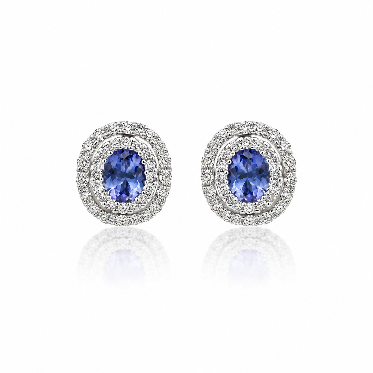 Oval tanzanite and diamond double halo stud earrings in white gold
