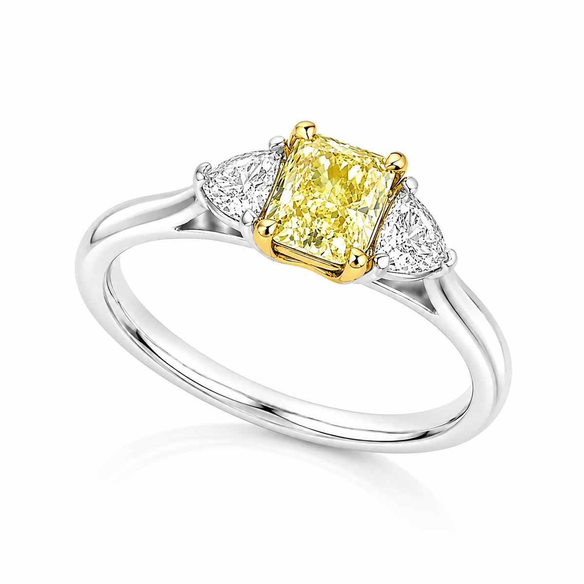 The Sol platinum trilogy ring with GIA-certified 0.71ct VS2 natural Fancy Yellow radiant cut diamond and white diamond side stones.