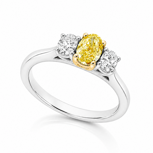 The Amaterasu Platinum 950 trilogy ring with GIA-certified 0.37ct VS2 natural Fancy Intense Yellow oval diamond and white diamond side stones.