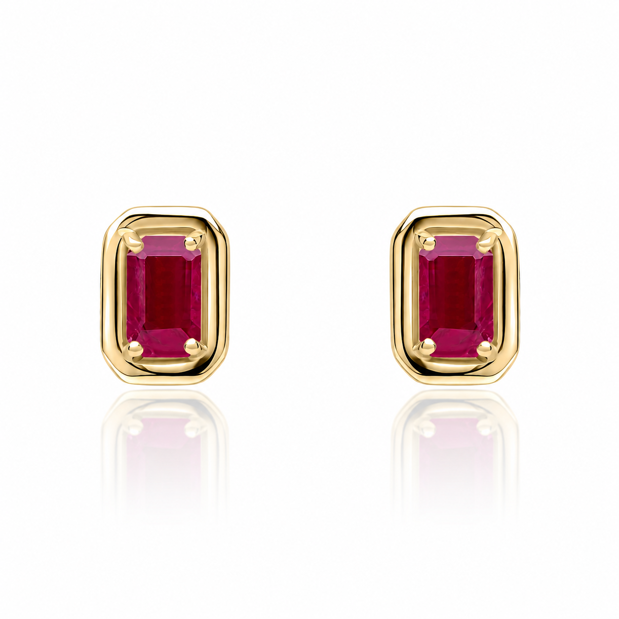 Natural ruby stud earrings worn on ear in 9ct yellow gold
