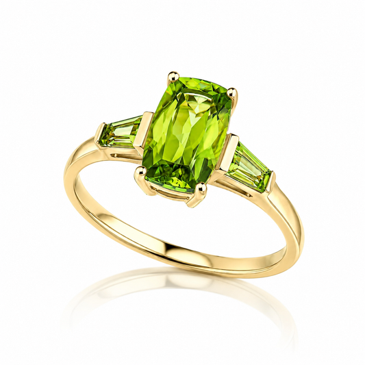 9ct yellow gold trilogy ring featuring a rectangular cut peridot with trapezoid peridot side stones