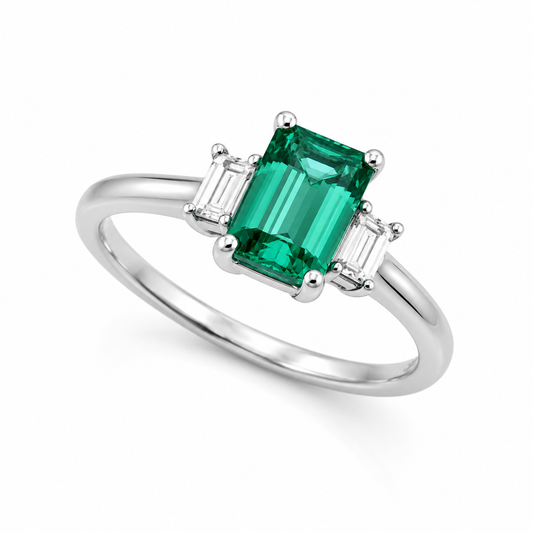 Emerald-cut green tourmaline and tapered diamond three-stone ring