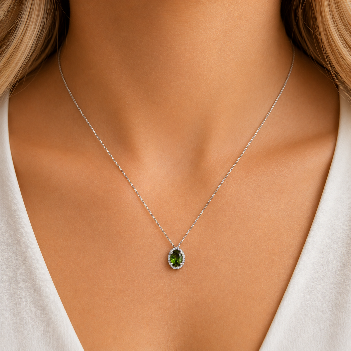 Oval green tourmaline pendant with forest and olive tones surrounded by diamonds