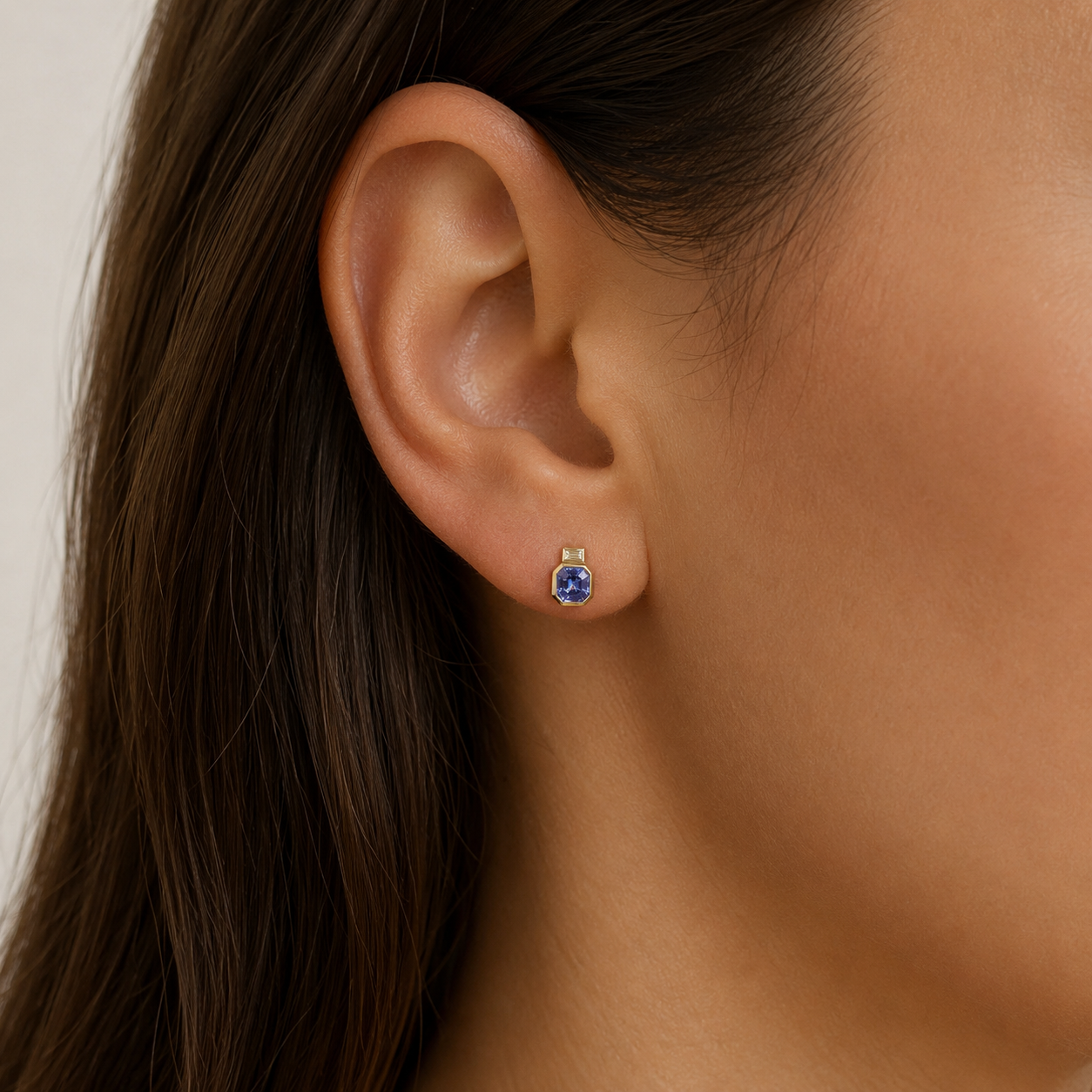 9ct yellow gold tanzanite and emerald-cut diamond drop earrings with rubover settings