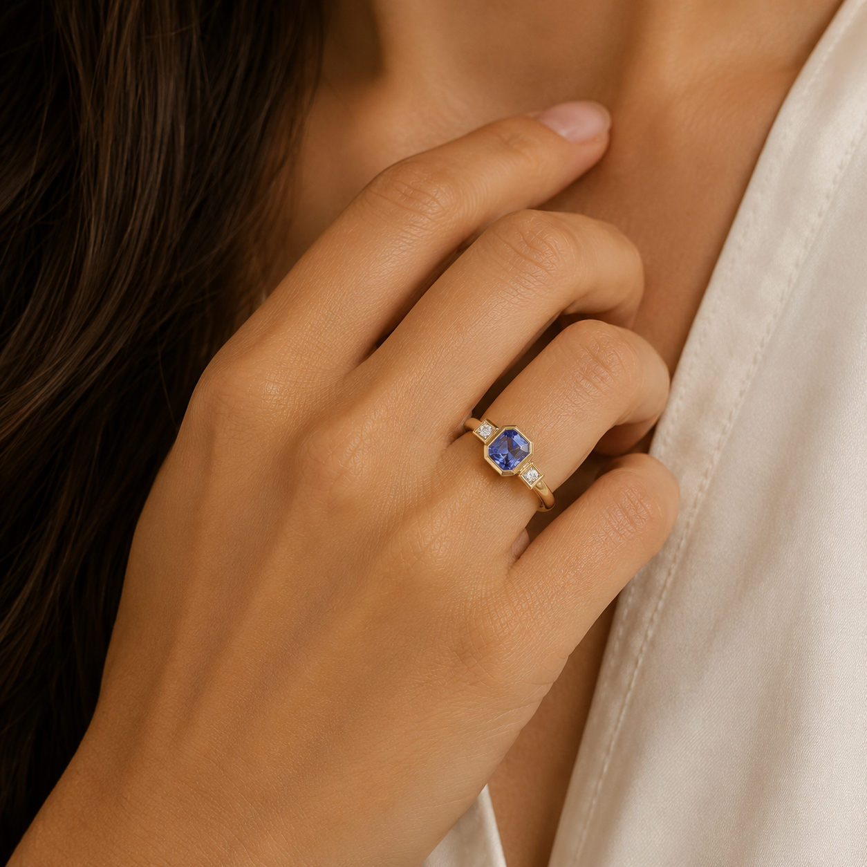 9ct yellow gold tanzanite ring with baguette diamonds and rubover setting