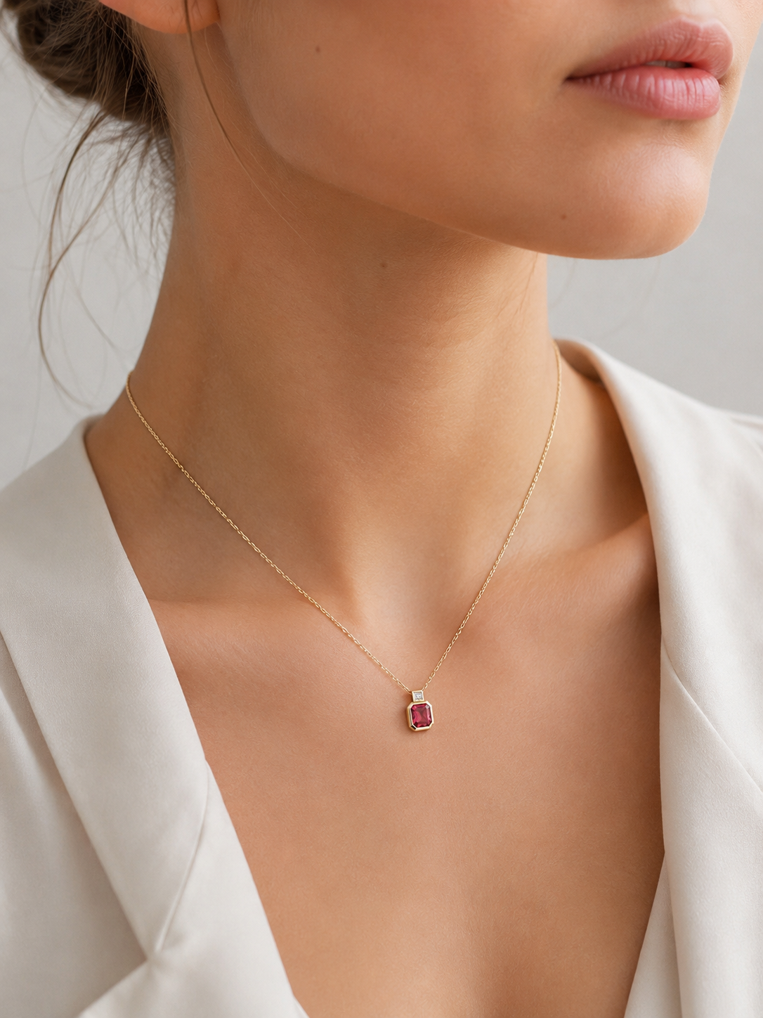 Model wearing pink tourmaline necklace featuring an octagonal tourmaline and emerald-cut diamond pendant