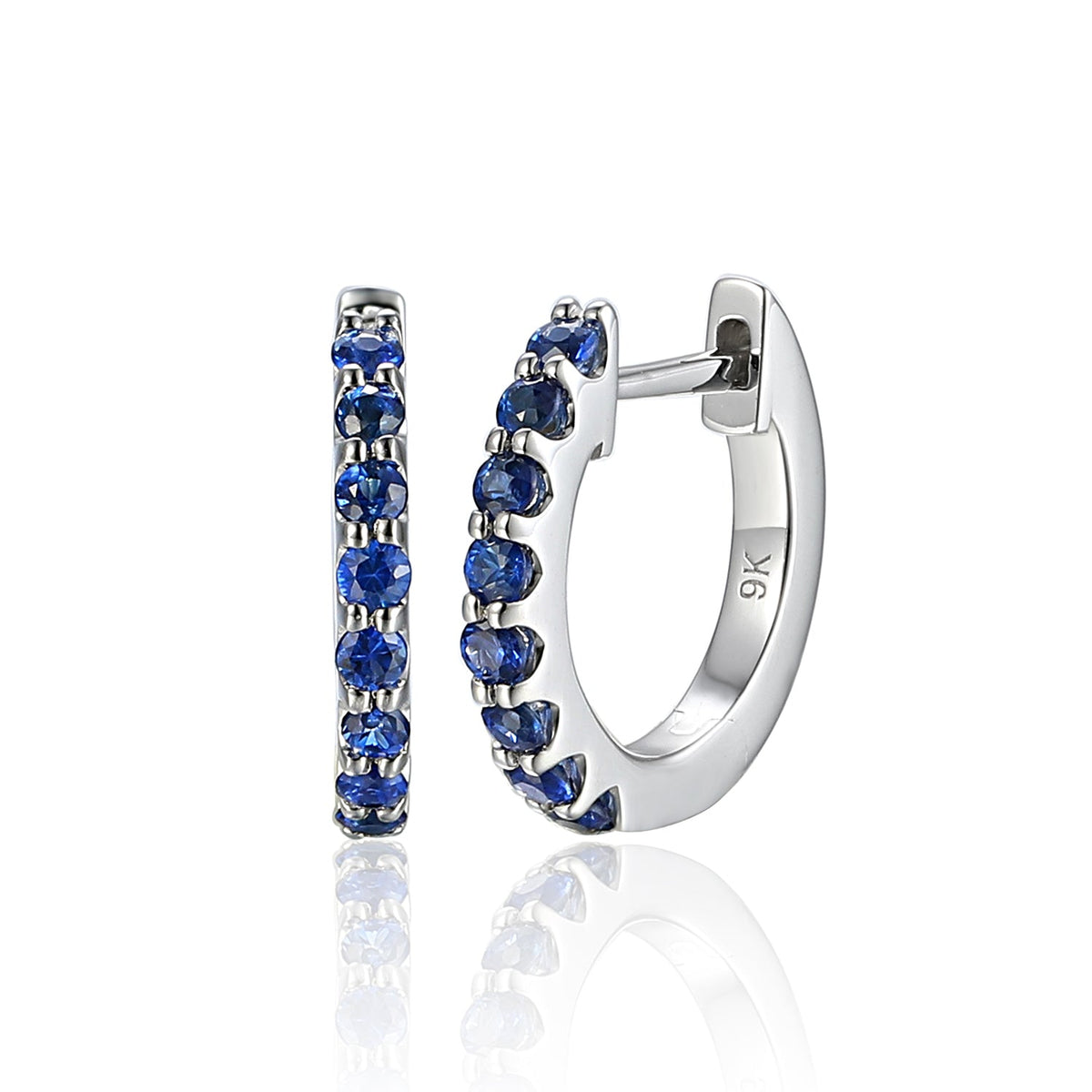 Céleste white gold hoop earrings claw-set with a row of round blue sapphires and post and clip fastenings.