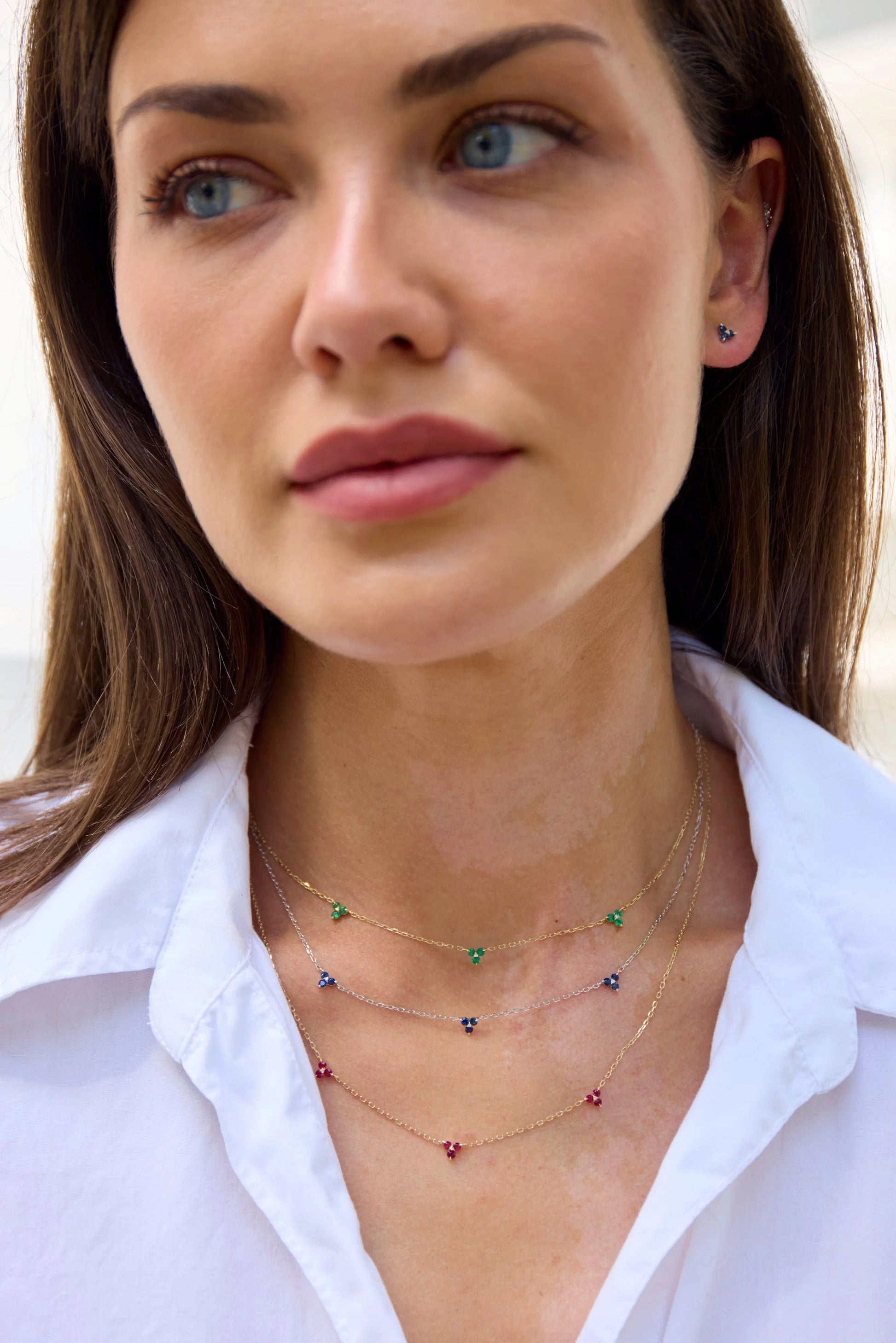 Model wearing a yellow gold triple peridot necklace from The House of Gemstones collection