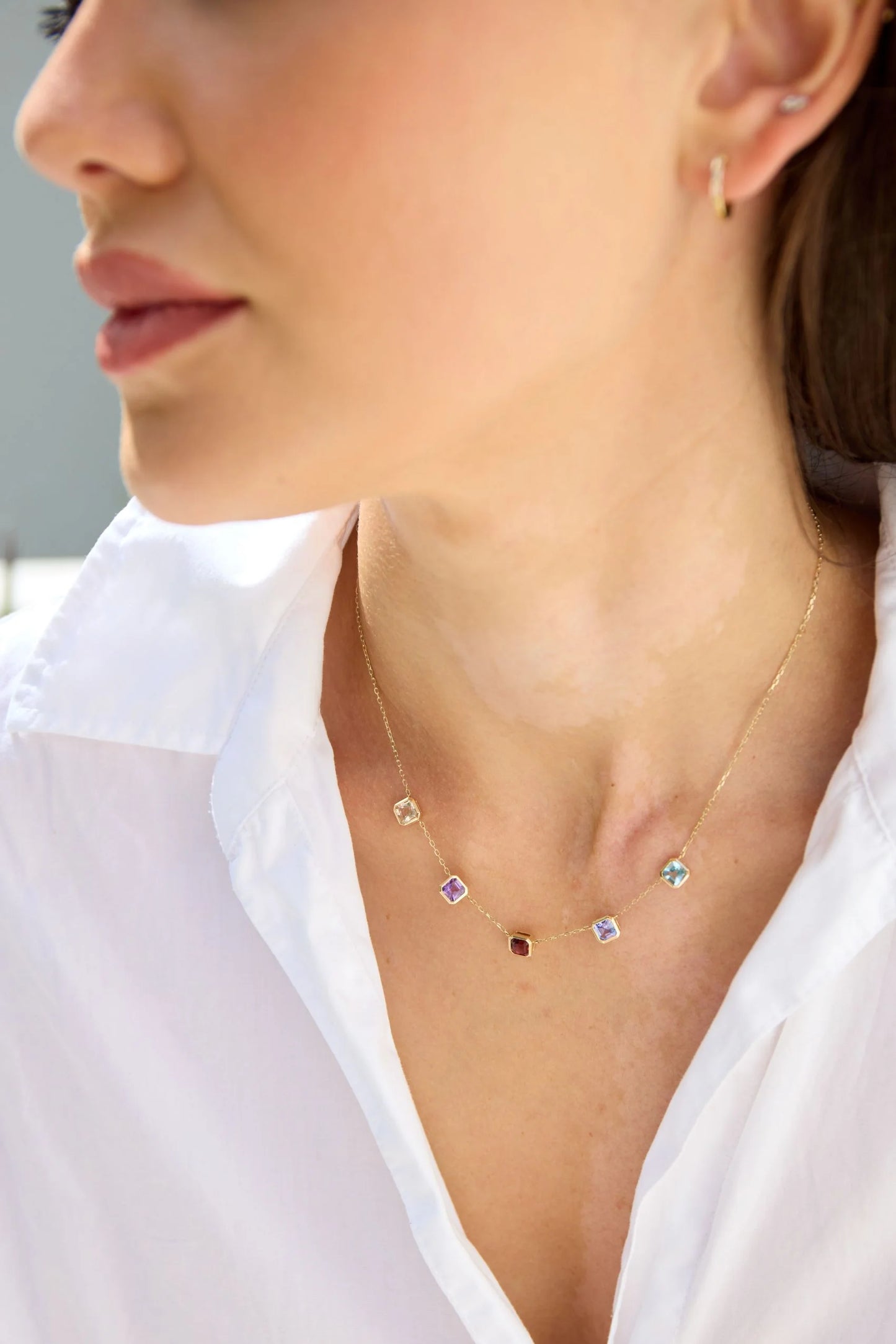 Multi-gemstone necklace featuring square step cut morganite, amethyst, pink tourmaline, tanzanite and aquamarine set in gold