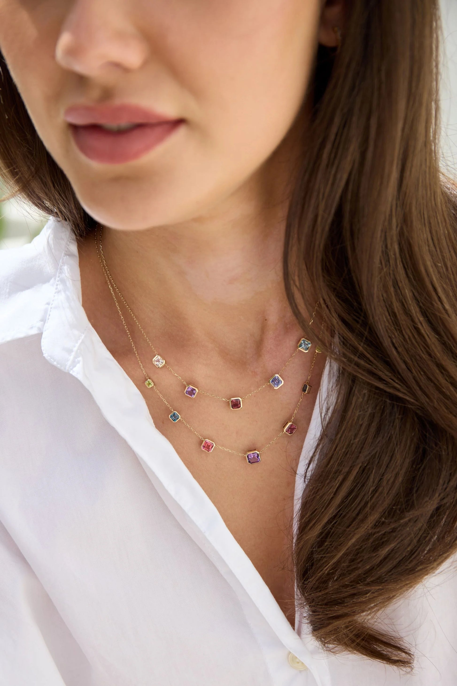 Multi-gemstone necklace featuring square step cut morganite, amethyst, pink tourmaline, tanzanite and aquamarine set in gold