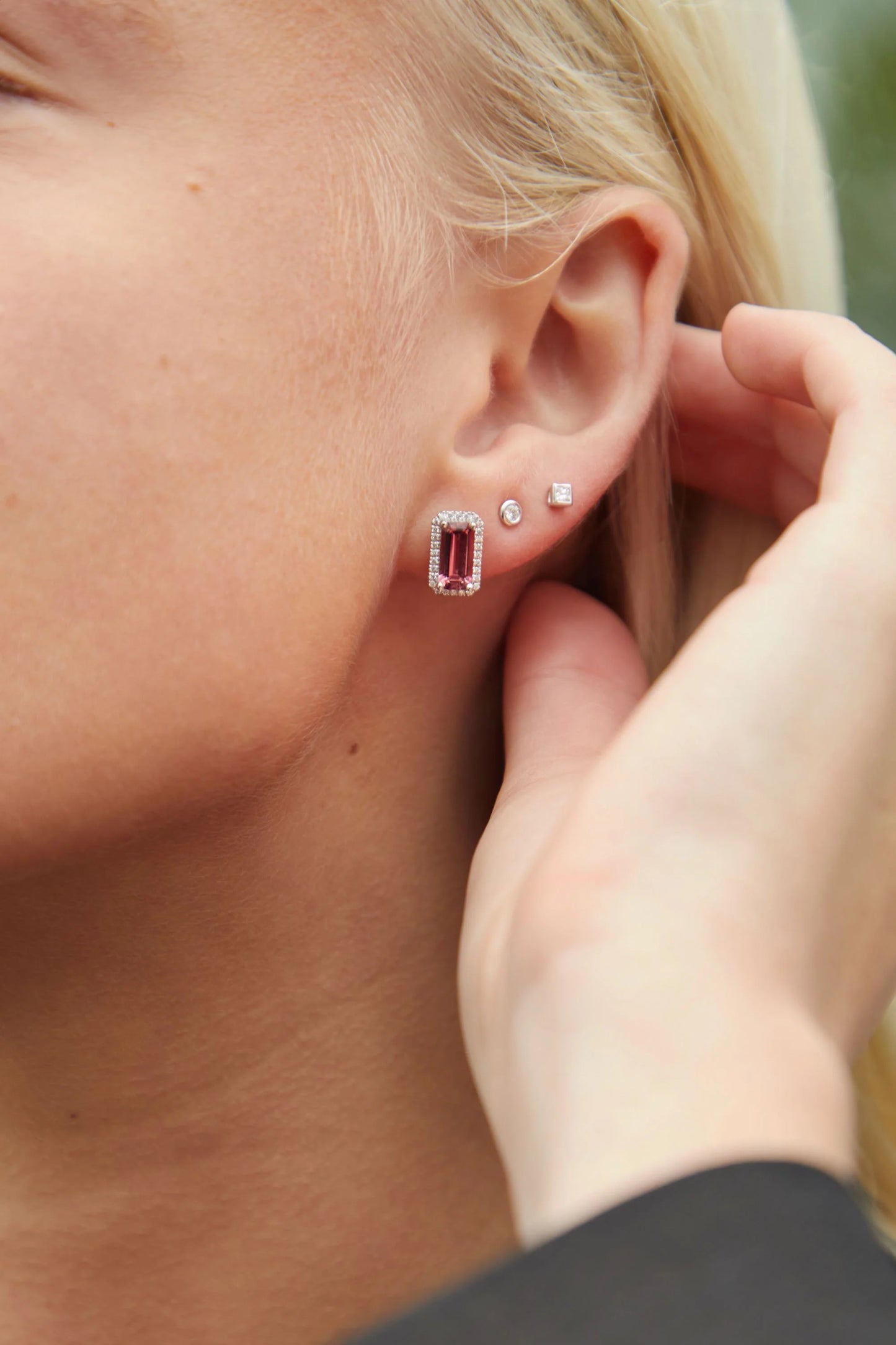18ct white gold pink tourmaline and diamond halo stud earrings with emerald-cut pink tourmalines and brilliant-cut diamond surrounds.