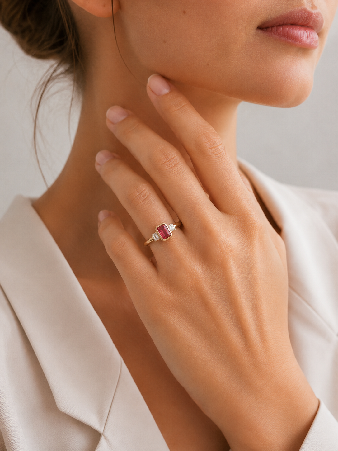 Pink tourmaline octagon ring with emerald-cut diamonds in gold rubover settings