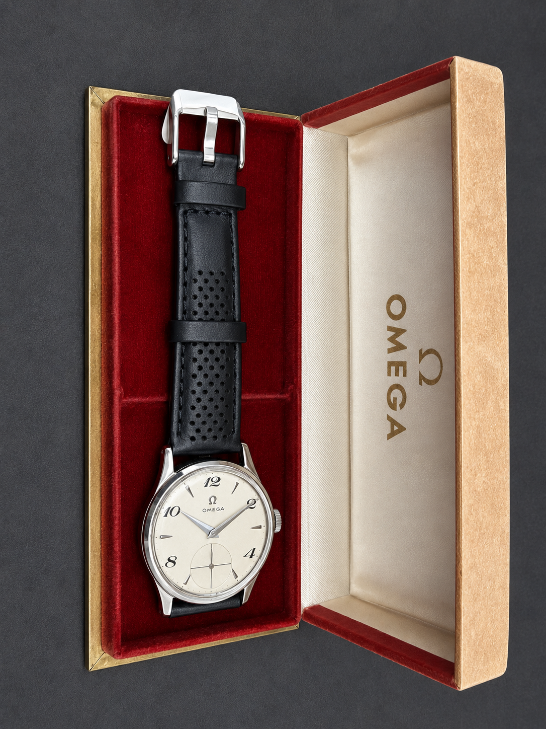 Vintage Omega manual wind wristwatch with silver dial, Arabic numerals, small seconds display and black perforated leather strap.