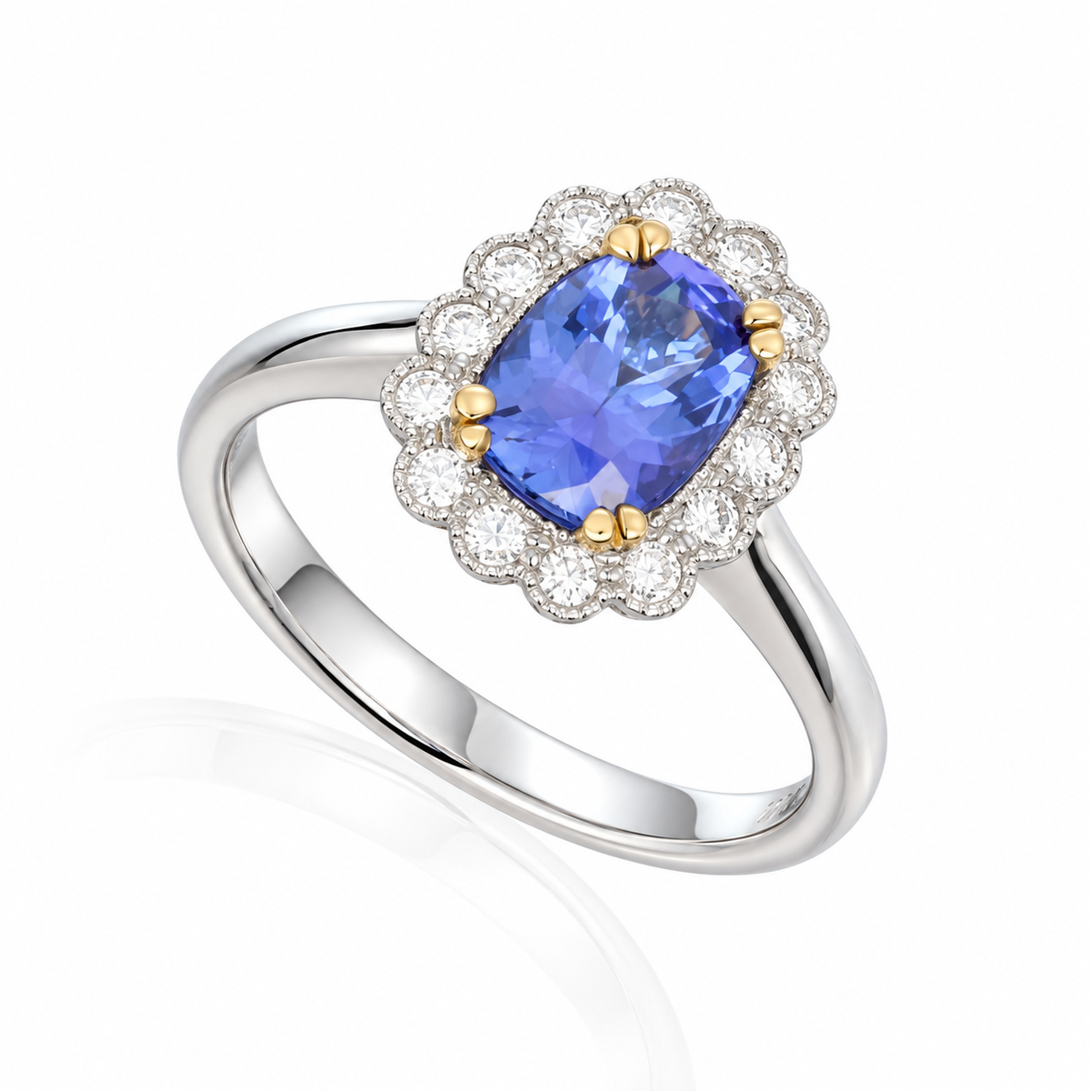 18ct white gold tanzanite and diamond halo ring featuring an 8x5 oval tanzanite surrounded by 14 round diamonds.