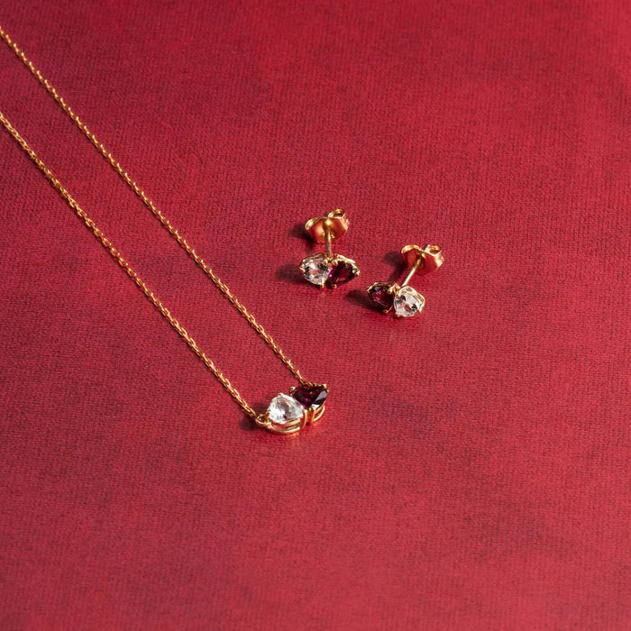 Heart cut white topaz and rhodolite garnet set side by side in 9ct yellow gold