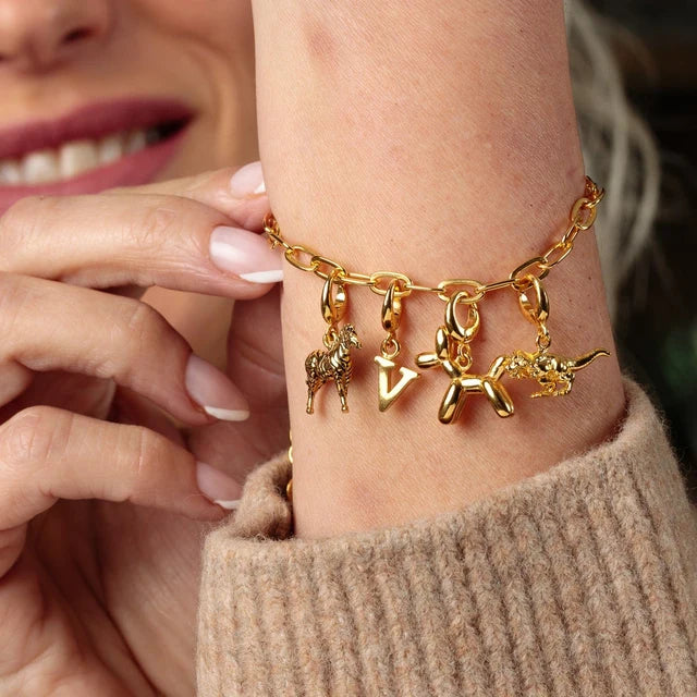 Lily Charmed gold balloon dog charm in 18ct gold-plated recycled sterling silver on a bracelet with other charms