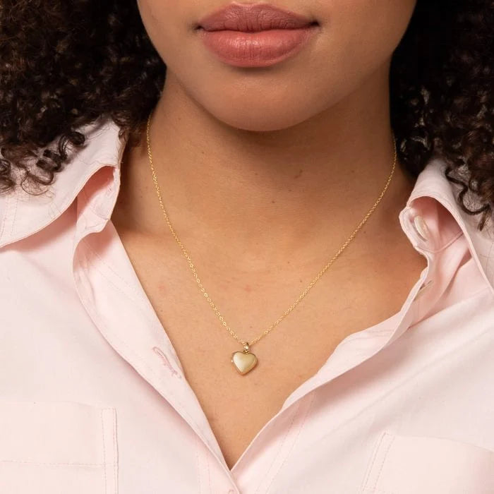9ct yellow gold polished heart locket necklace with decorative beaded bale on the model