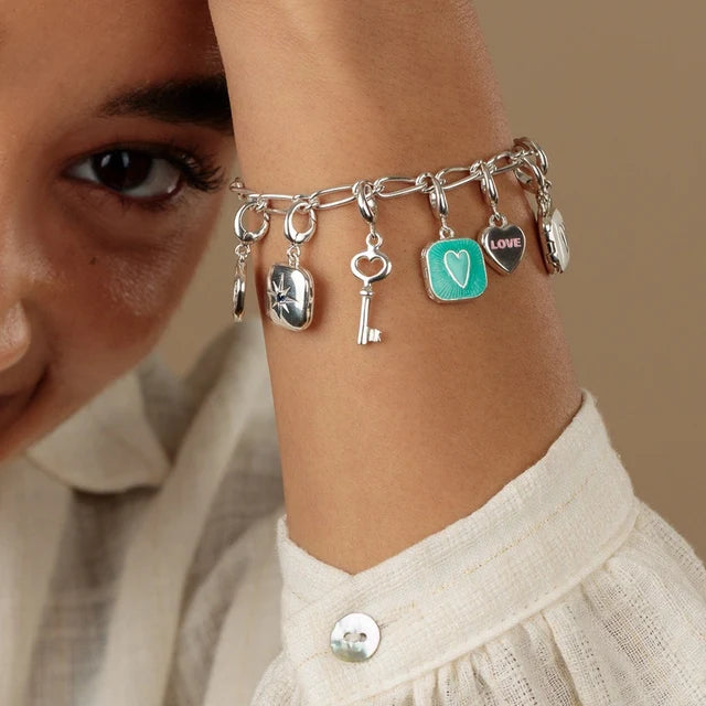 Lily Charmed silver heart locket charm with turquoise enamel and raised heart detail on a bracelet