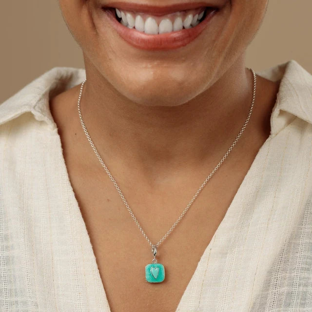 Lily Charmed silver heart locket charm with turquoise enamel and raised heart detail on a chain